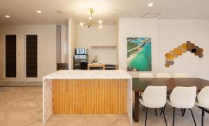 a kitchen and dining room with a table and chairs at Priyado Kochi in Kochi