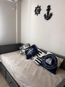 a bed with pillows on it in a bedroom at Sea and Cinema,two bedrooms apartment in Loutraki