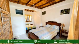 a bedroom with two beds in a room at Suites Villa Colombia in Puerto López