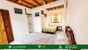 a bedroom with a bed and a bed sqor at Suites Villa Colombia in Puerto López +12 photos