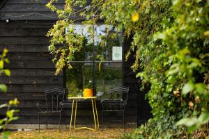 a table with a potted plant on it in front of a building at The Stables in Kampen