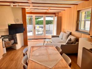 a living room with a couch and a table at Tiny Haus Dornbirn in Dornbirn