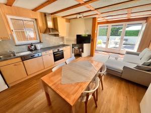 a kitchen and living room with a table and a couch at Tiny Haus Dornbirn in Dornbirn