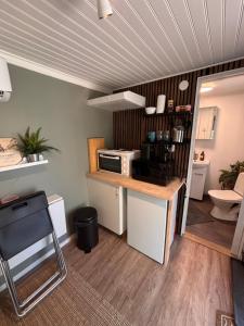 a kitchen with a counter and a microwave in a room at Murrebo citystay in Örebro +13 photos