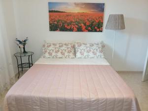 a bed in a room with a painting on the wall at La Casa Bianca in Camerano +16 photos