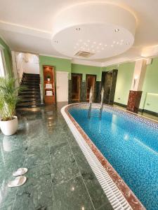 a swimming pool in the middle of a building at Vila Angel in Bečići