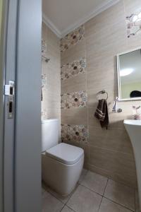 a bathroom with a toilet and a sink at Shamba la Chini in Nairobi +48 photos
