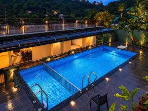 a swimming pool on the roof of a building at Sky Dale Pool Resort Munnar in Munnar