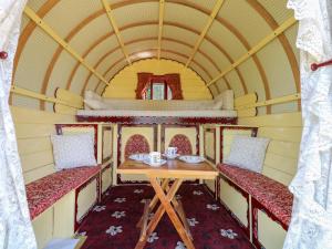 a table and two chairs in a train room at The Bowtop Gypsy Caravan in Eye