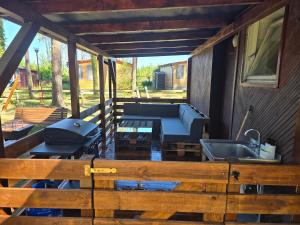 a screened in porch with a grill and a sink at Domek Wakacyjny Patrycja 47 in Głębokie +3 photos