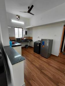 an empty room with a kitchen and a living room at AGM Spacious Private AC 1BHK with Hall, Kitchen & Bath in Udupi