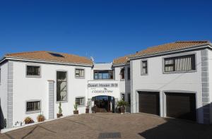 a large white building with a first house bc dispensary at Classical View Guesthouse in Mossel Bay +12 photos