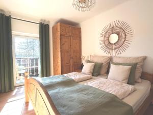 a bedroom with a bed with a mirror on the wall at Stefflhof in Gabersdorf