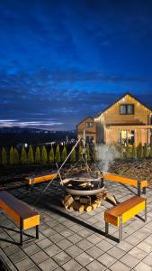 a boat on a fire pit with two benches at Lipowe Love in Lipowa