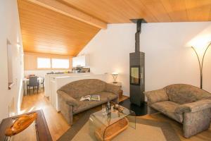 a living room with two couches and a stove at Ca' Melin with Balcony & Fireplace - Happy Rentals in Mugena