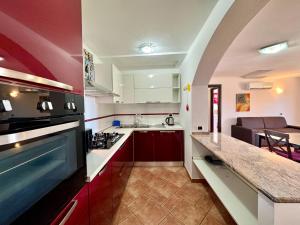 a kitchen with a sink and a stove top oven at Orange House in Bari Sardo