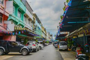 a busy city street with cars parked on the street at The Backpack Hostel in Bangkok +13 photos