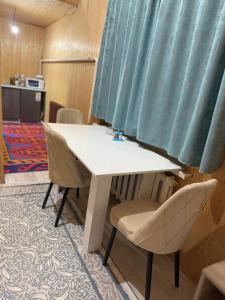 a white table and chairs in a room at Perizat in Saty