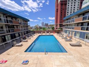 a large swimming pool on the side of a building at SOHO Suites Atlantic City Beach Block in Atlantic City