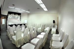 a room with rows of white chairs and a stage at Abell Hotel in Kuching +38 photos