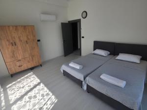 a bedroom with a large bed and a wooden cabinet at ViLLA ANGEL AHMET HASAN in Belek +13 photos