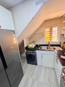 a kitchen with a sink and a dishwasher at Sea-Point Homes in Maiyegun