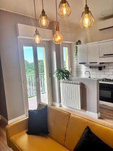 a living room with a couch and a kitchen at BradAmare Seafront in Montesilvano