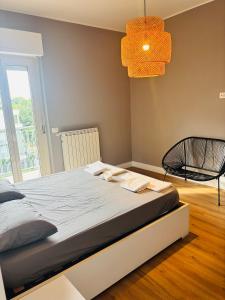 a bedroom with a bed and a black chair at BradAmare Seafront in Montesilvano