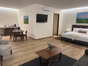 a bedroom with a bed and a living room with a table at Casa Américas in Mexico City