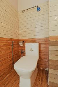 a bathroom with a white toilet in a wooden wall at Hotel Lekali Homes in Kathmandu +20 photos