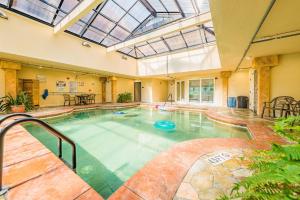 a large indoor swimming pool with an indoor at Good Trouble - Croatan Surf Club, Ocean View, Indoor and Outdoor Pool, Hot Tub, Pets Ok, YR Flex in Kill Devil Hills