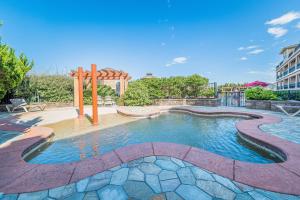 a swimming pool with a playground in a park at Good Trouble - Croatan Surf Club, Ocean View, Indoor and Outdoor Pool, Hot Tub, Pets Ok, YR Flex in Kill Devil Hills