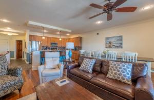 a living room with a couch and a table at Good Trouble - Croatan Surf Club, Ocean View, Indoor and Outdoor Pool, Hot Tub, Pets Ok, YR Flex in Kill Devil Hills +65 photos