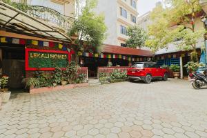 a red car parked in front of a building at Hotel Lekali Homes in Kathmandu