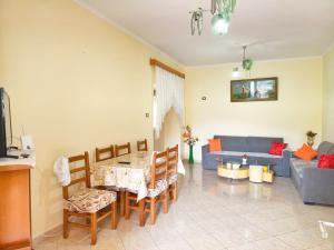 a living room with a table and a couch at Shtepi Manuel in Sarandë