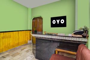 a bar with an ovo sign on a green wall at Super Hotel O by OYO Kavish Residency in Haridwār