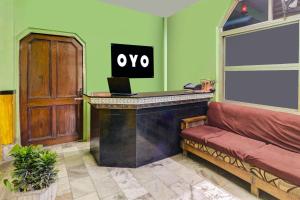 a bar in a room with a couch and a desk at Super Hotel O by OYO Kavish Residency in Haridwār