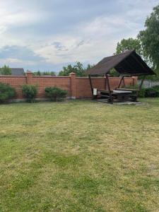 a picnic table in a yard next to a brick wall at Ангеліна in Svityazʼ