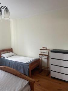 a bedroom with two twin beds and a dresser at Ангеліна in Svityazʼ