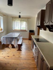 a kitchen with a table in the middle of it at Ангеліна in Svityazʼ