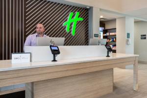 a man standing at a counter in a pharmacy at Holiday Inn - Tampa North by IHG in Tampa +62 photos