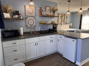 a kitchen with white cabinets and a sink at The Mark at Surfside #8 in Surfside Beach