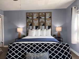 a bedroom with a large bed with two lamps at The Mark at Surfside #8 in Surfside Beach