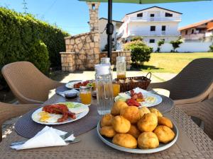 a table with plates of breakfast food on it at Nova Rooms Velipojë in Velipojë