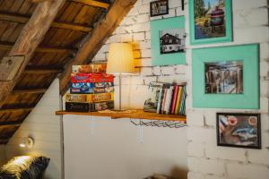 a room with a shelf on a wall with books at Lakamajutus, telkimisala ja saunakompleks Pihtla Õlleköögis in Pihtla