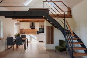 a staircase in a living room with a table and chairs at Ferienhaus am Dillbach in Hagen
