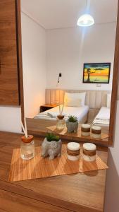 a room with a bed and a table with plants at White house 2 Ksamil in Sarandë