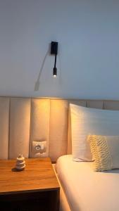 a bedroom with a bed with a desk and a light at White house 2 Ksamil in Sarandë