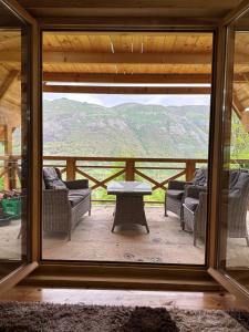 a view from the window of a cabin with couches and a table at Vila Gorska in Šavnik