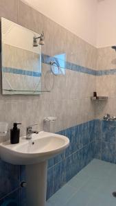 a bathroom with a sink and a mirror at White house 2 Ksamil in Sarandë